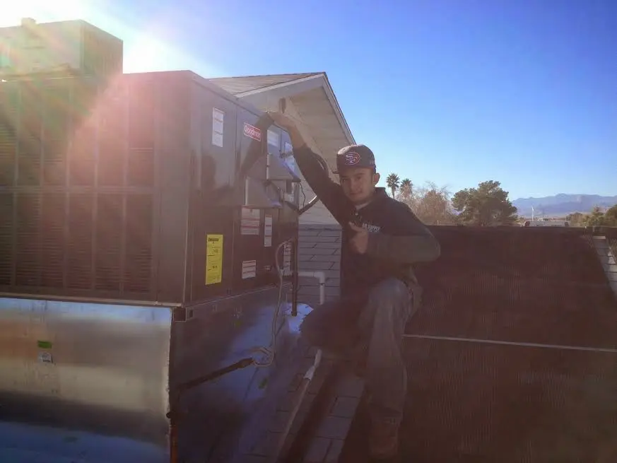 HVAC technician performing Boiler Repair on a rooftop unit in Ceres
